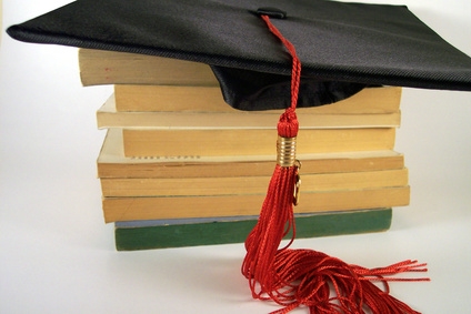 graduation cap on top of a stack of books