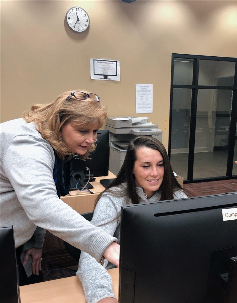 Student working with professor on a computer