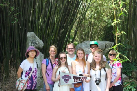 Students holding up a Roanoke College banner in China