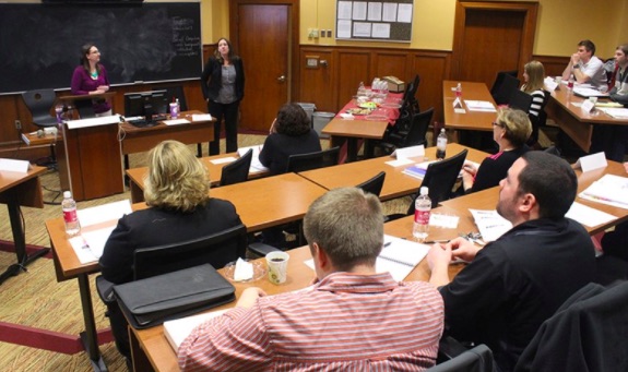 Students listen to a class in a lecture room