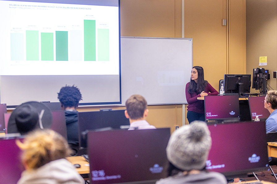 student explaining data graph during presentation