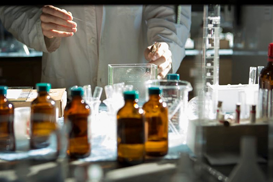 Close-up of student's hands while working with lab equipment