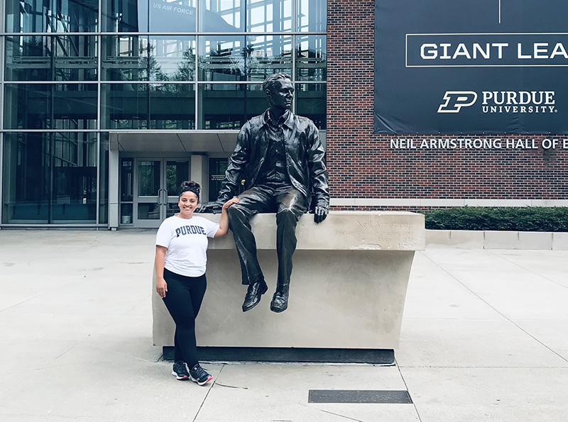 Photo of Razan “Rosie” Hamed wearing a Roanoke shirt on the campus of Purdue