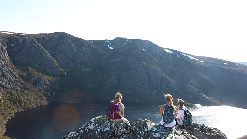 Figures overlooking moutain ridge