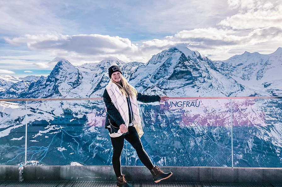 student in front of alps