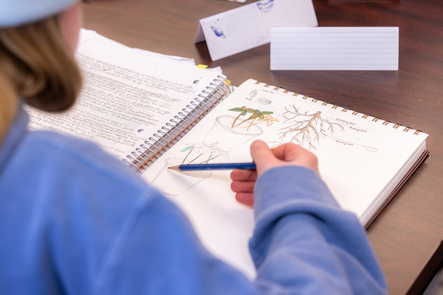 student writing in notebook about cannabis horticulture 