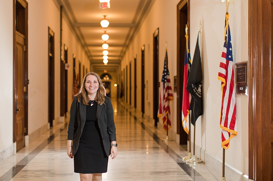 student with American flag in the background