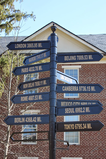 Signpost showing how many miles away certain cities are