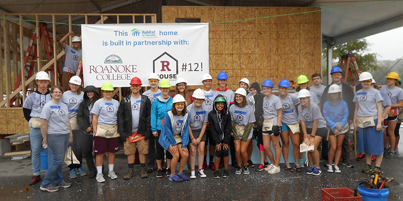 Students posing by the R House