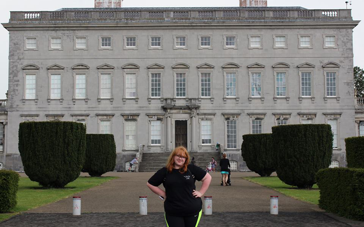 Caitlin Wright smiles for a picture outside a historical building