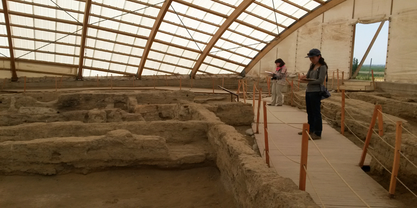 Student walk through an archeological site