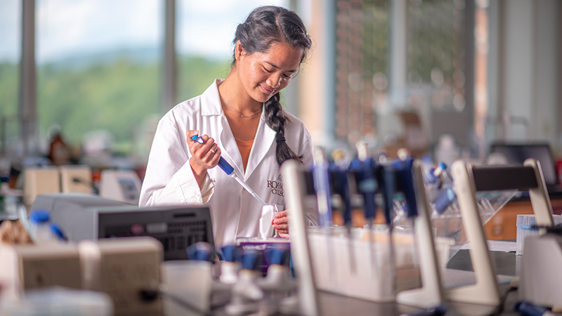 student using lab equipment