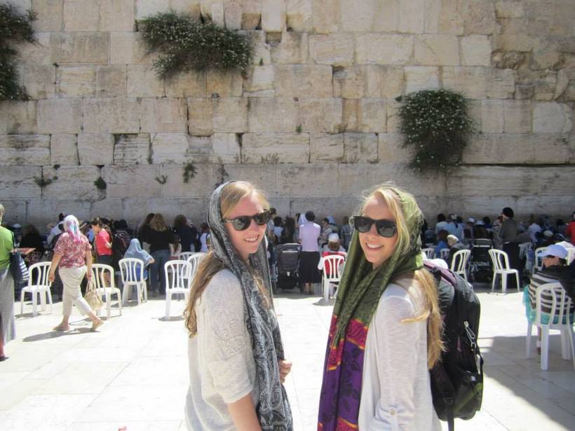 Students at a massive wall in Israel