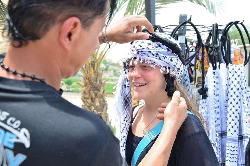 Local Arab helping a Roanoke student put on an Arab scarf