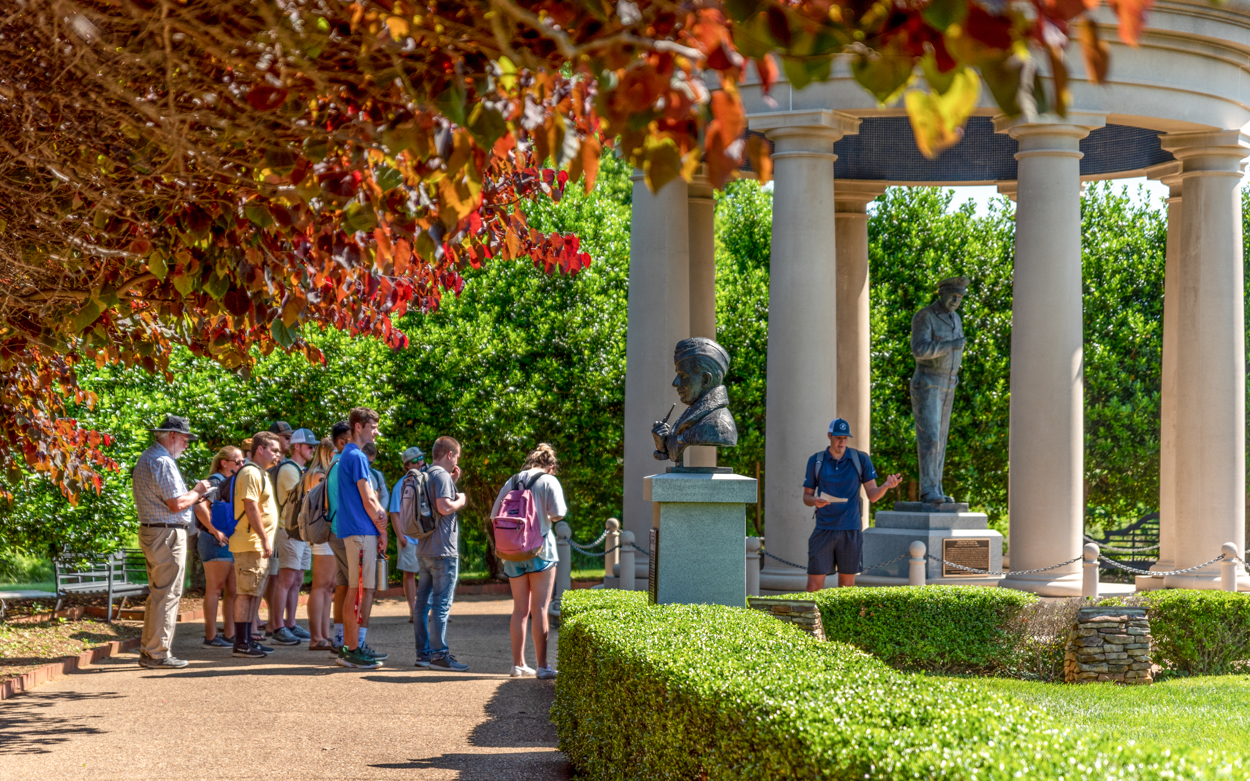 students learning about statues