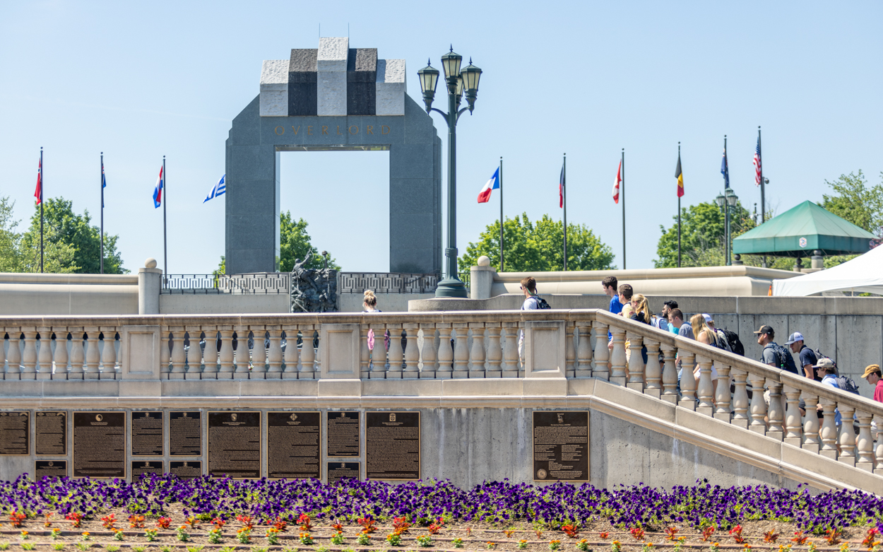 students walking up stairs at a monument