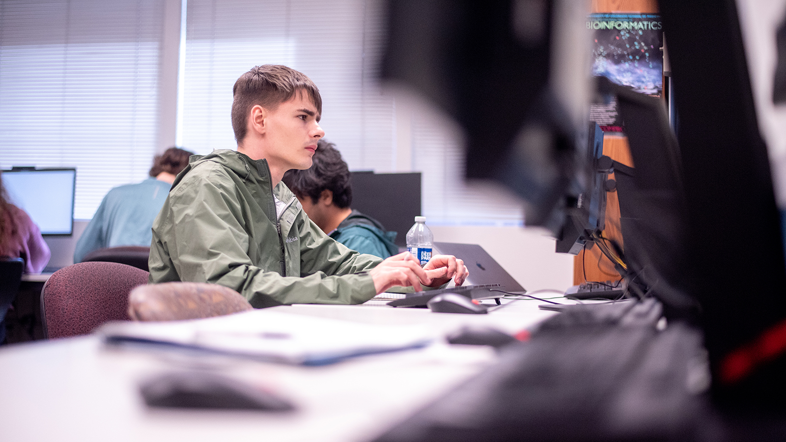 Computer Science students working on laptops