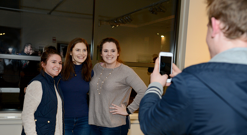 Amanda Knox takes photos with students