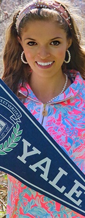 Emma Kessler holding a Yale pennant flag