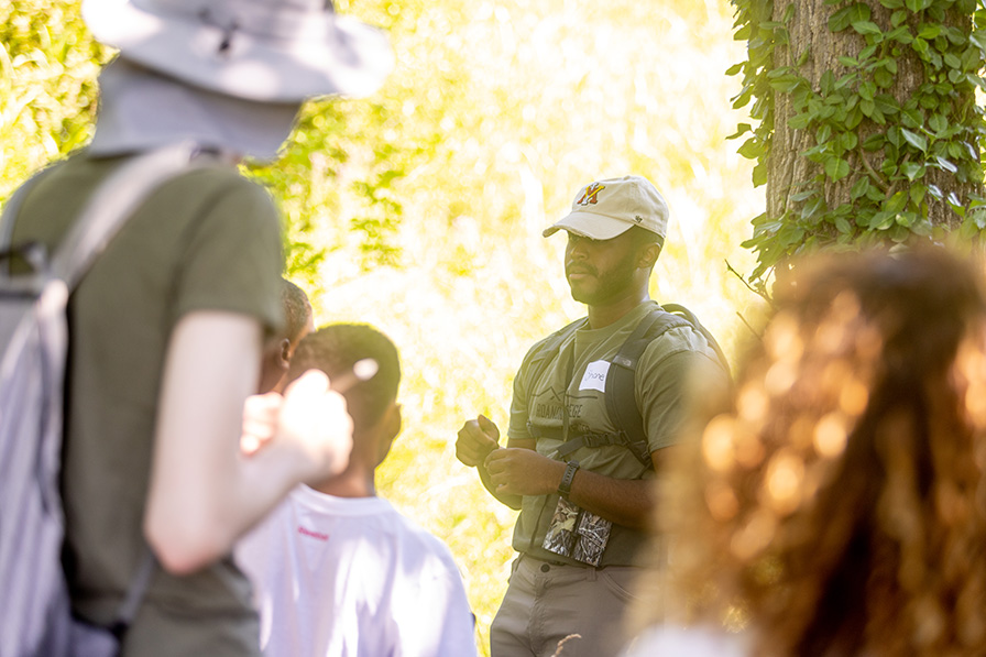Person talking to a crowd in the forest