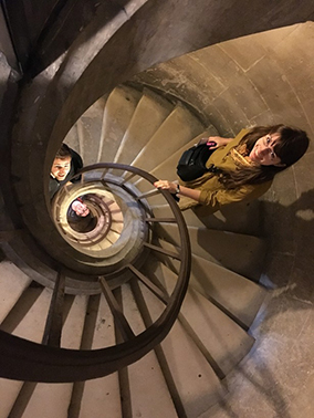Photo from above of students on a spiral staircase