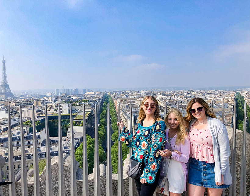 Students at a lookout looking over the city of Paris