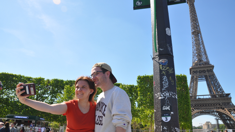 Students taking a picture in front of the Eiffel Tower