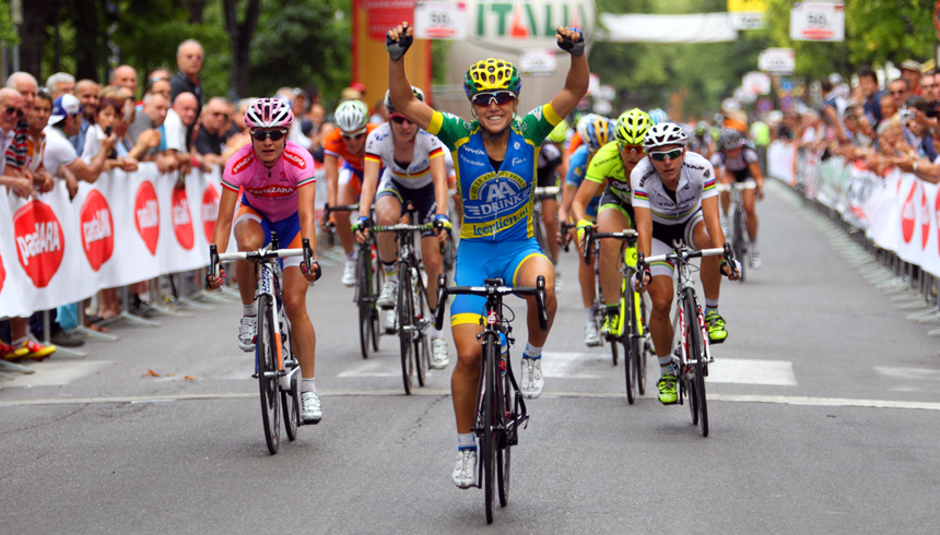 Shelley Olds smiles and raises her hands in triumph after crossing the finish line in a race