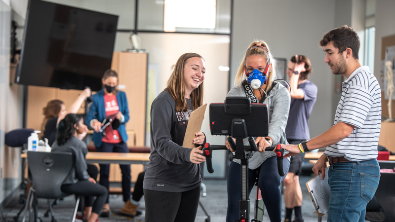 Students monitoring someone on an exercise bike