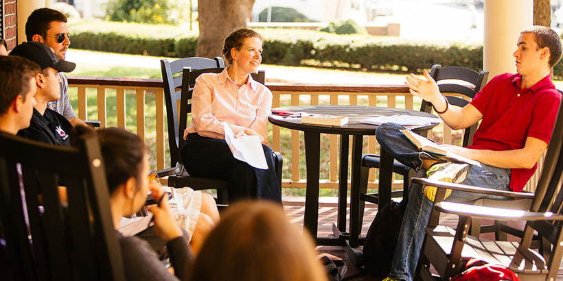 Professor Mary Henold talking with students