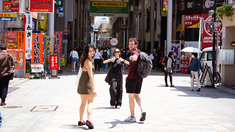 Cameron McDonald in Japan walking down a busy pedestrian street