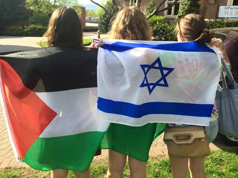 Students holding flags from different countries