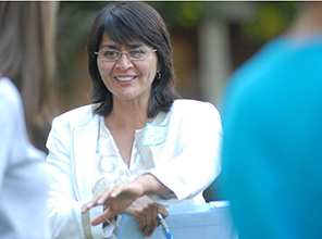 Dr. Flores-Silva smiles while talking with other people