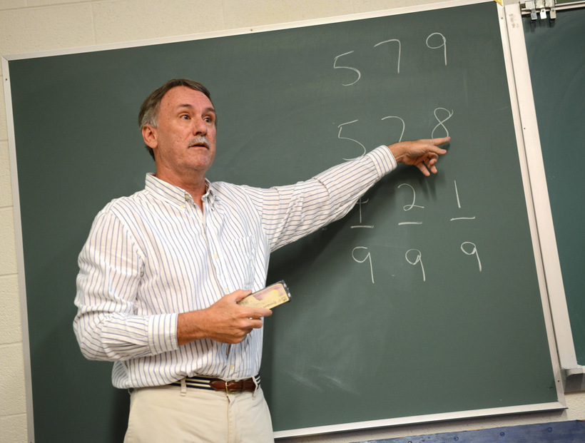 Professor explaining math behind a magic trick