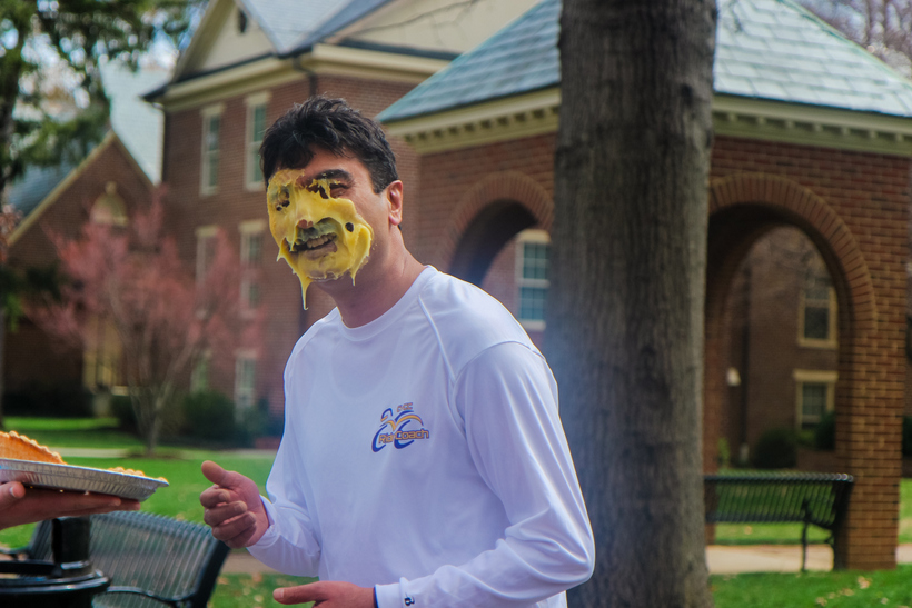 Student with pie all over his face