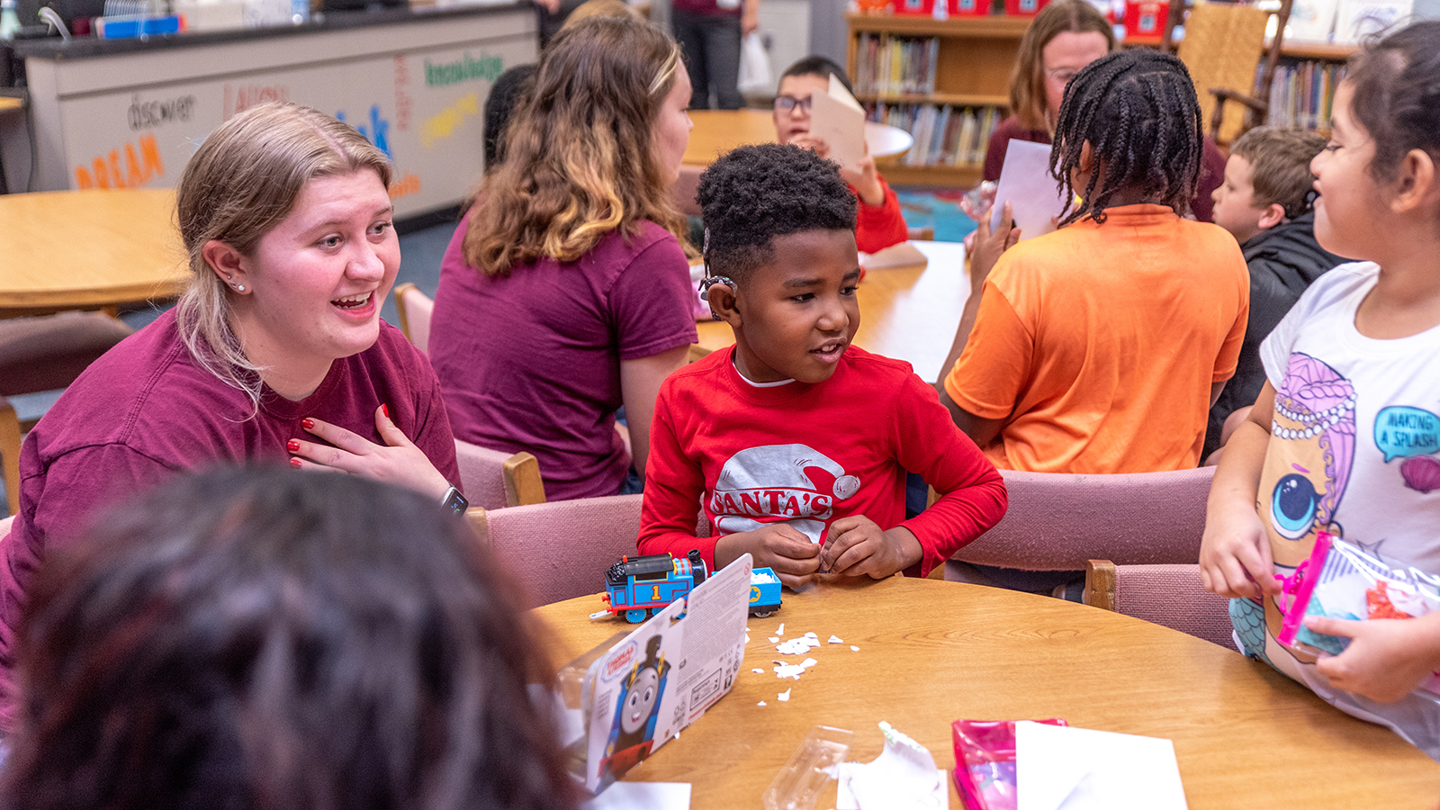 Students working with young children