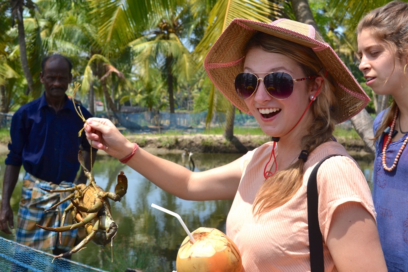 Student holding up a large crab