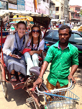 Students in a little cart pulled by a bike