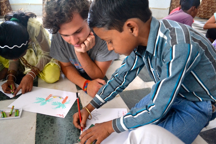 Student with a child doing a drawing