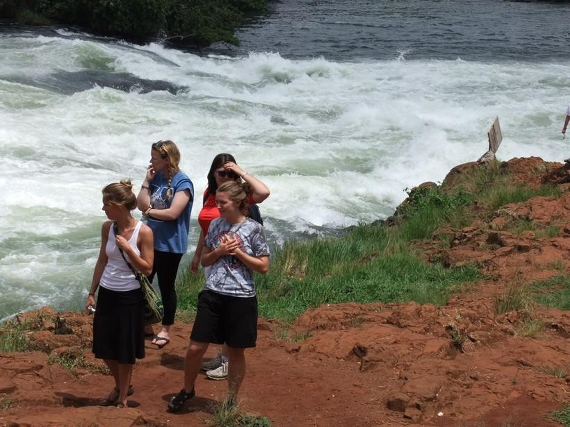 Students walking on a trail along a river