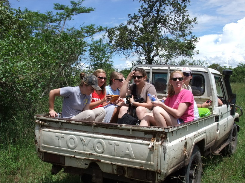 Students sitting in the bed of a pickup truck