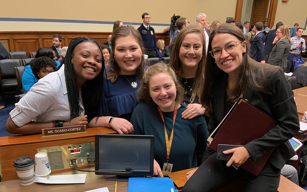 Olivia Kitt '20 and other posing with Representative Alexandria Ocasio Cortez