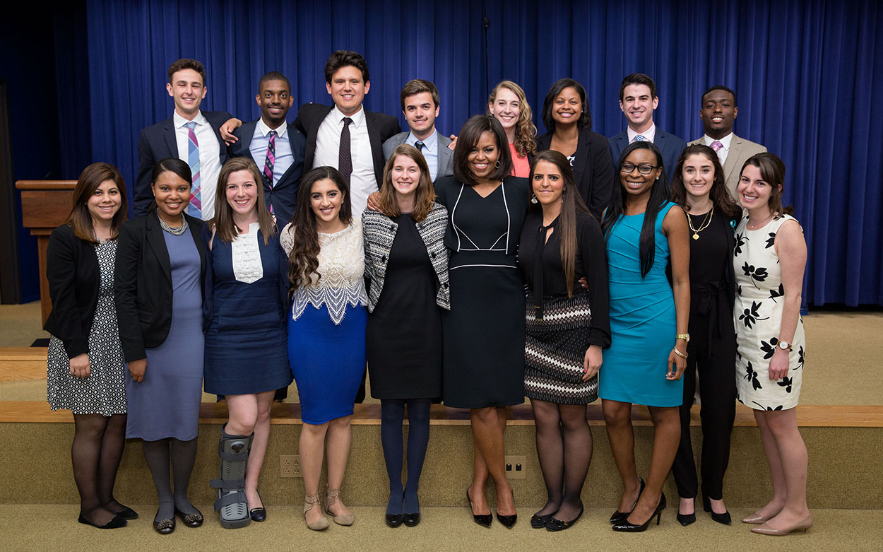 Group of students standing together with Michelle Obama