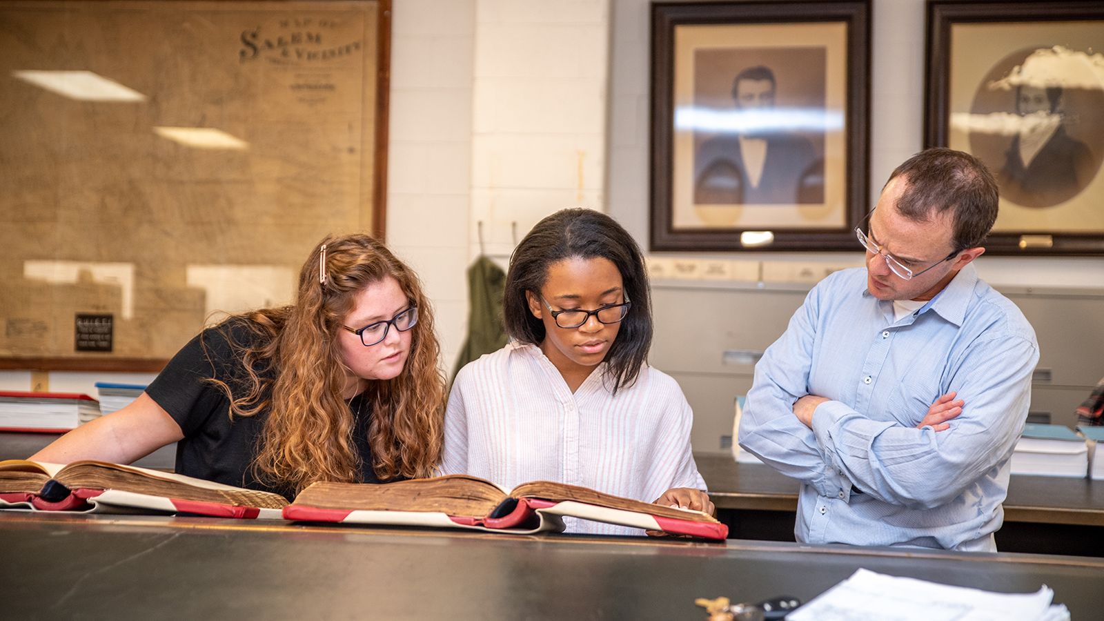 Students reading with professor