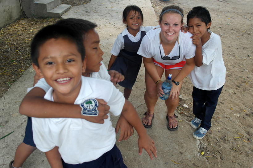 Student with children in Belize
