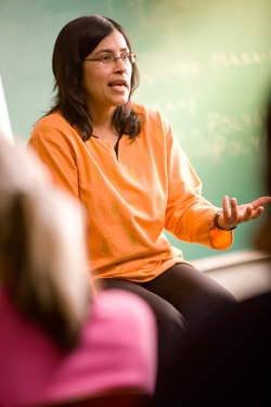 professor sitting and talking to students