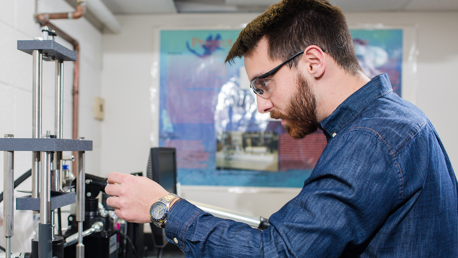 Student working on wiring for a machine