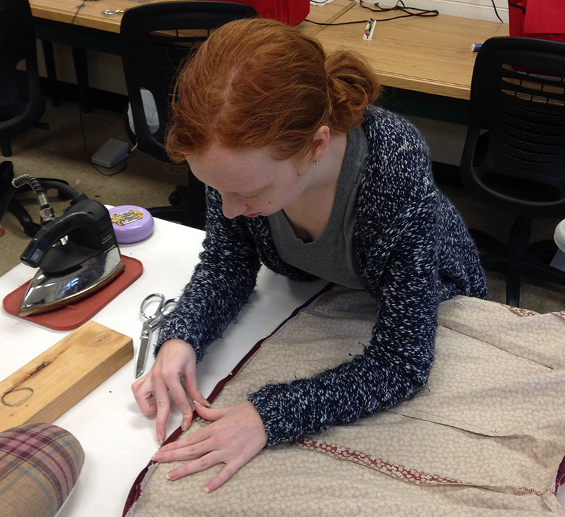 student works on a costume