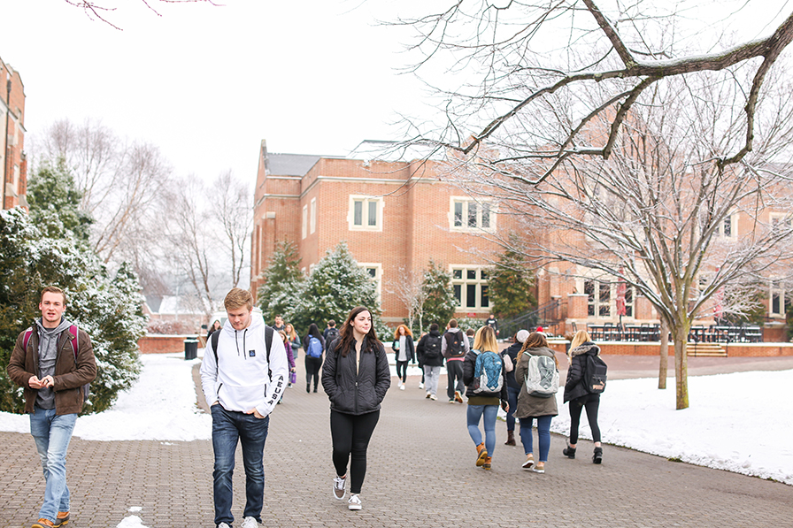 students walking to class with snow on the ground