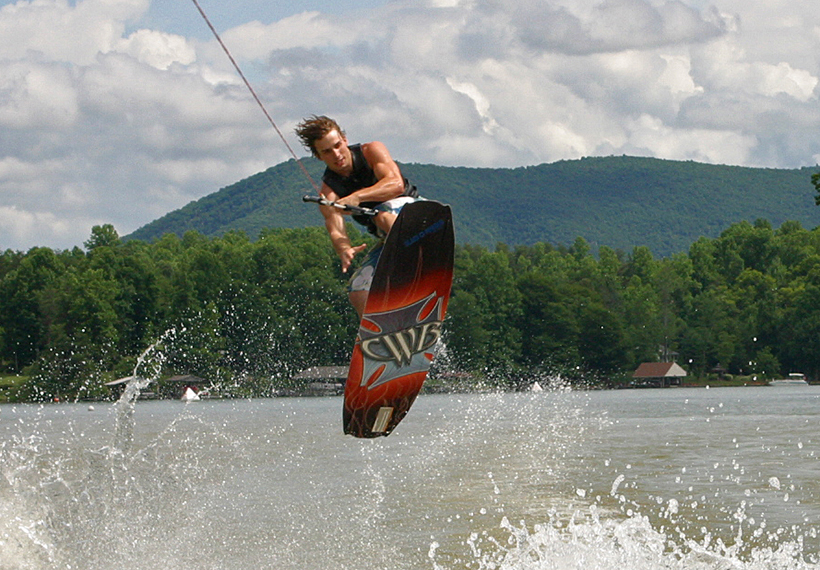Student wakeboarding on a lake